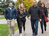 Photo: family walking on campus
