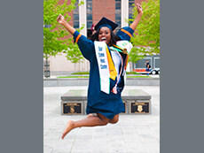 Photo: a 2017 graduate jumping after Commencement
