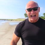 Tom laidlaw smiling on beach
